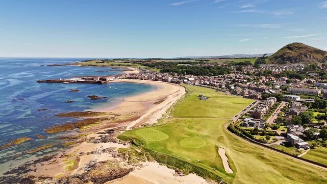 Scotland, East Lothian, North Berwick, West Links. An aerial perspective overlooking the lush greens of the West Links golf course beside the sandy shores of the Firth of Forth. 