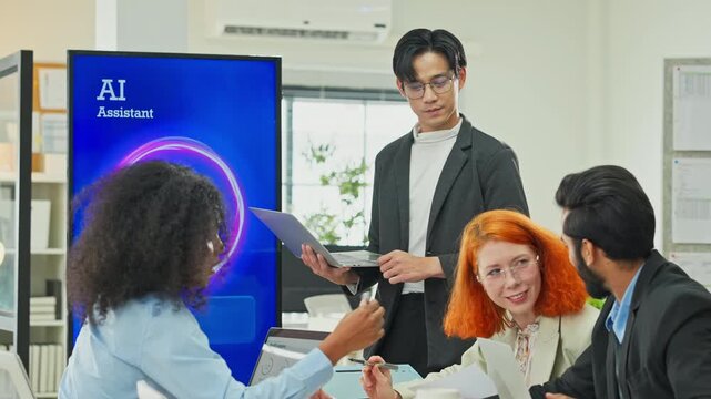 Smart Asian businessman presenting AI backend system replacing human marketing data management to partners and programmers in modern open office, business restructuring and automation concept