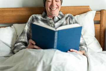 Fototapeta premium Relaxed reading in cozy bed