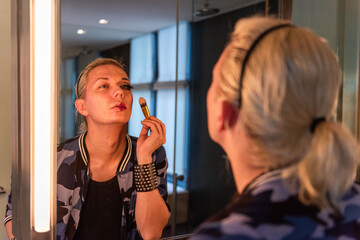 Person applying makeup in mirror. © Rawpixel.com