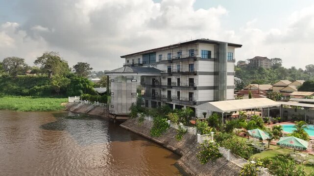 Congo River, DR Congo - a modern riverside building with a pool, aerial drone view