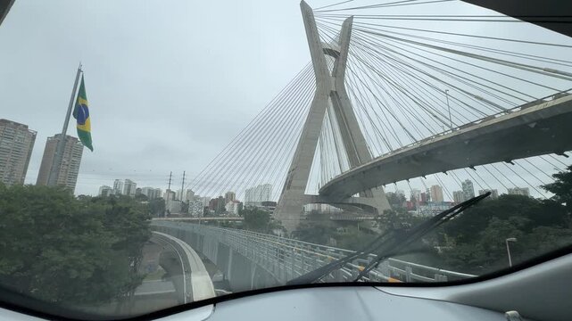 View of the Octávio Frias de Oliveira Cable-Stayed Bridge from the front cabin of the Line 17 Gold monorail in São Paulo, Brazil. The image features one of the city's most iconic landmarks.