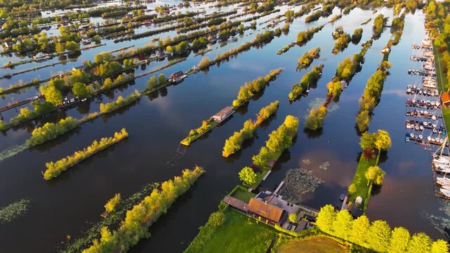 Aerial drone view the harbour of Scheendijk Loosdrechtse Plassen, a floating village in the Netherlands at sunset. High quality 4k footage