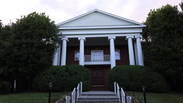 Classic mansion with white columns and front steps