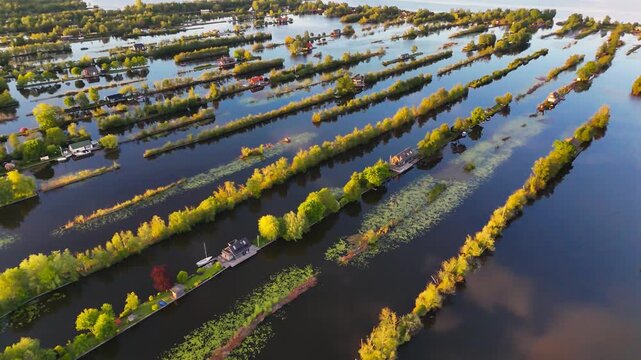 Aerial drone view the harbour of Scheendijk Loosdrechtse Plassen, a floating village in the Netherlands at sunset. High quality 4k footage