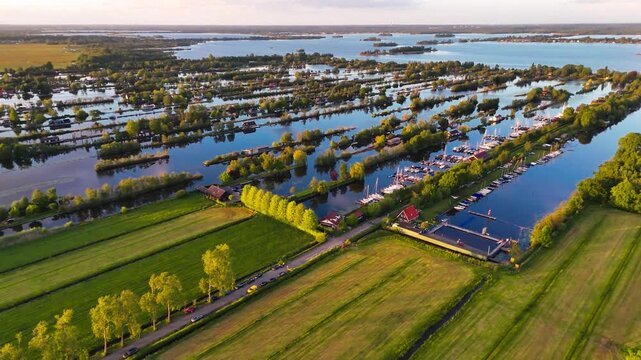 Aerial drone view the harbour of Scheendijk Loosdrechtse Plassen, a floating village in the Netherlands at sunset. High quality 4k footage