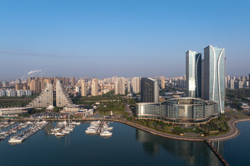 Obraz premium Qingdao Olympic Sailing Center modern architecture complex with yachts docked in harbor bay