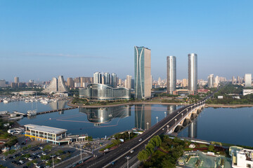 Fototapeta premium Xiamen Wuyuan Bay modern architecture complex and sea-crossing bridge under clear morning sky