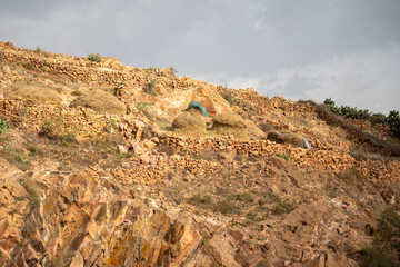 Piles of hay on a rocky slope in a village on the outskirts of Asmara, Eritrea © Angela