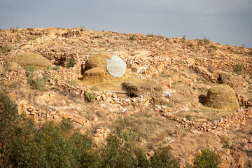 Piles of hay on a rocky slope in a village on the outskirts of Asmara, Eritrea © Angela