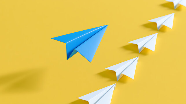 Blue paper airplane leads a line of white paper planes, symbolizing leadership, innovation, and breaking away from the norm on a vibrant yellow background