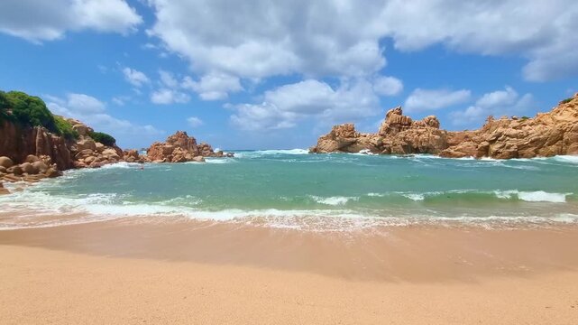 Beautiful turquoise sea, rocks and golden sand on Li Cossi beach, in sunny summer day, in Sardinia, Italy