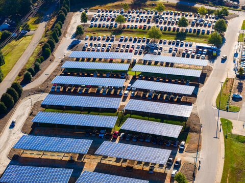 Photovoltaic solar panels over car parking lot in Clemson, South Carolina for generation of renewable energy. Sustainable power production integrated in urban infrastructure.