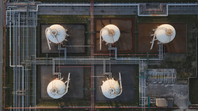 Portugal - 25 June 2026: Aerial view of oil refinery tanks and pipelines with complex networks of industrial pipes and storage infrastructure.