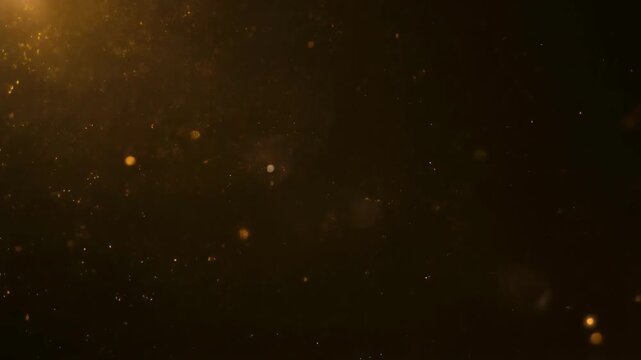 Golden dust particles floating in dark cinematic background with warm bokeh light