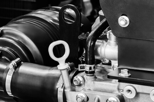 Cose-up car engine with oil level gauge in crankcase in  foreground. Auto repair and maintenance concept background