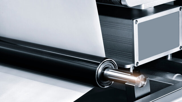 A large industrial offset printing machine prints an image on packaging film. tech industrial technology background