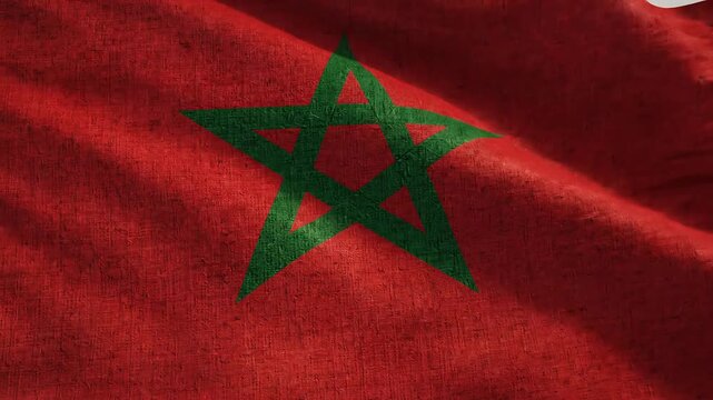 Moroccan flag with green star on red fabric background, national symbol of morocco