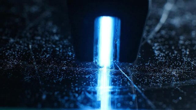 Closeup of a hockey puck and stick on an ice rink illuminated with blue light