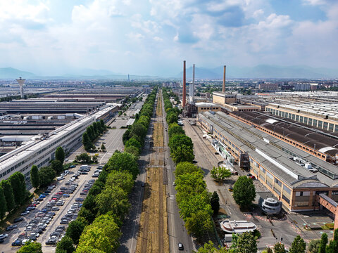 Torino, Piemonte, Italy - 24 June 2026: Aerial view of the Stellantis Battery Technology Center featuring large industrial factory buildings, a central tree-lined road, and parking lots.