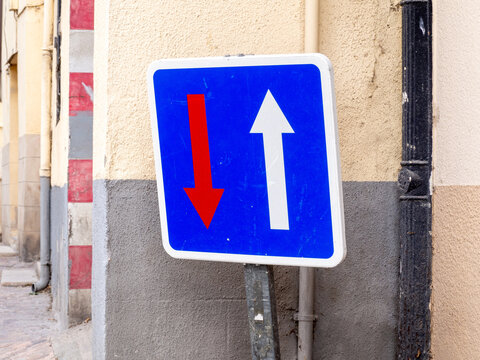 Blue traffic sign indicating priority over oncoming vehicles
