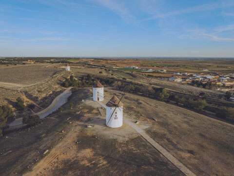 Aerial view of the historic Windmills Manchegos on a hill overlooking the town of Mota del Cuervo, Castilla-La Mancha, Spain.