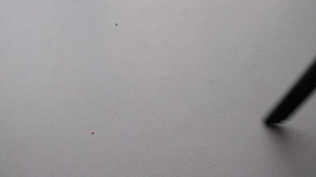 Cleaning small beads from a flat surface with a portable vacuum cleaner
