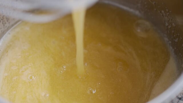 Egg and sugar mixture is whisked in metal bowl during cake batter preparation. Concept of homemade baking and dessert making