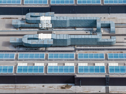 Aerial view of the Factory Annopol roof featuring large industrial ventilation ducts and rows of skylights in Warszawa, Wojewodztwo mazowieckie, Poland.