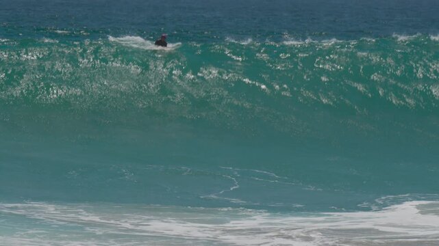 Surfer trying to catch shorebreak wave