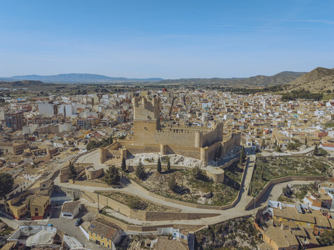 Aerial view of the historic Castle of Atalaya overlooking the town of Villena with its traditional rooftops and surrounding hills in Villena, Valencian Community, Spain.