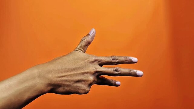 Hand showing three fingers gesture counting number 5 on orange background