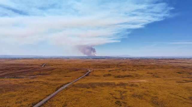 Golden plains stretch beneath vibrant blue sky