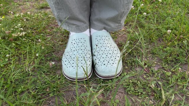 Close-up of slip-on shoes on the grass, casual summer footwear, and outdoor walks