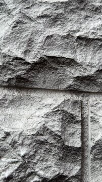 Close-up natural quartz facade panels showcasing rugged stone texture and modular layout, detailed grain and chiseled seams