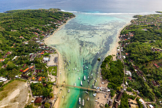 Beautiful tropical coastline with shallow water, boats and coastal villages