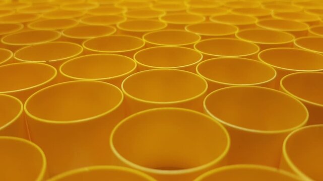 Static macro video of colorful plastic industrial parts pattern. Abstract manufacturing background with geometric texture and selective focus.