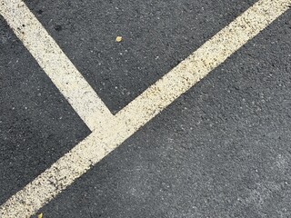 Fototapeta premium Diagonal Parking Lot Lines on Asphalt Surface
