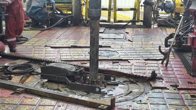 Drilling rig activity - Pull of of hole drill string with oil based mud on the rig floor. Trip out of hole.