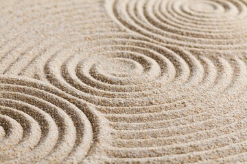 Obraz premium Zen garden sand with raked concentric circle patterns for meditation tranquility