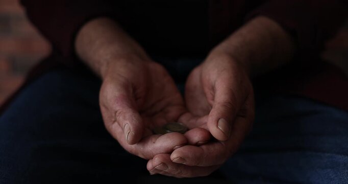 Poverty. People giving coins to homeless senior man indoors, closeup. Camera moving forward