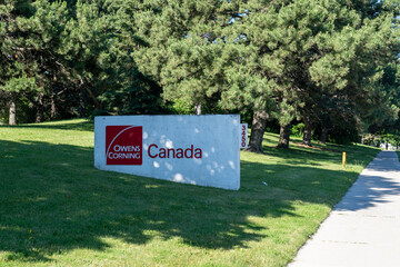 Fototapeta premium Toronto, Canada - June 27, 2026: The sign for Owens Corning Canada on McNicoll Ave in Scarborough, Toronto, Canada. Owens Corning is an American company that develops and produces insulation, roofing