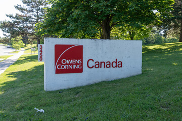 Fototapeta premium Toronto, Canada - June 27, 2026: The sign for Owens Corning Canada on McNicoll Ave in Scarborough, Toronto, Canada. Owens Corning is an American company that develops and produces insulation, roofing