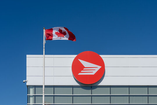 
Toronto, Canada - June 27, 2026: Flag of Canada and Canada Post logo displayed on the building in Toronto. Canada Post operates as a federal Crown corporation.
