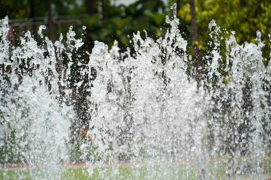 Dynamic water jets create a refreshing and lively display in a park setting