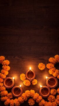 Beautiful deepavali floral arrangement with traditional clay oil lamps and marigolds