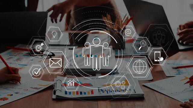 A dynamic workspace showcasing hands working on charts and graphs with digital icons symbolizing teamwork and effective communication in a business environment. Raster