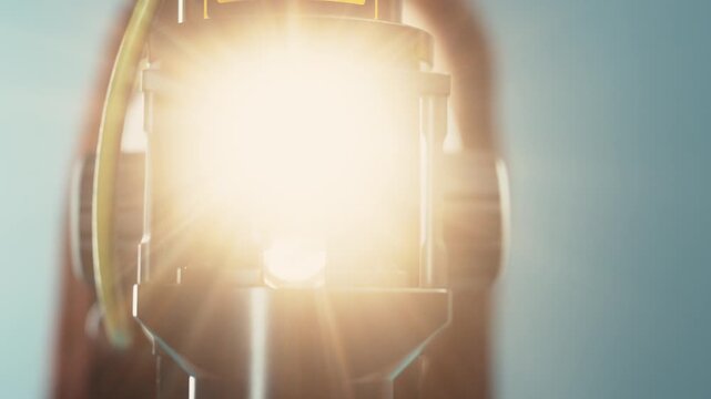 Slit lamp device illuminating eye during examination, showcasing detailed evaluation process with bright light and visible components in a clinical setting