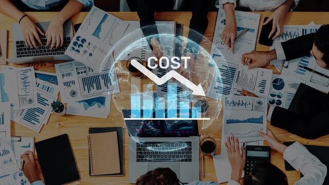 Aerial view of a business meeting with professionals analyzing cost data and graphs. Focus on teamwork and strategic planning for company growth and success. Raster