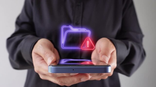 Risk in stored files. Businesswoman holds a cell phone with a virtual folder icon and a warning sign